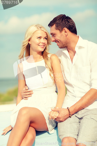 Image of smiling couple at sea side