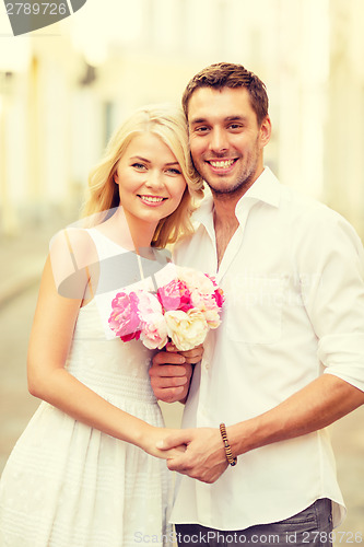 Image of couple with flowers in the city