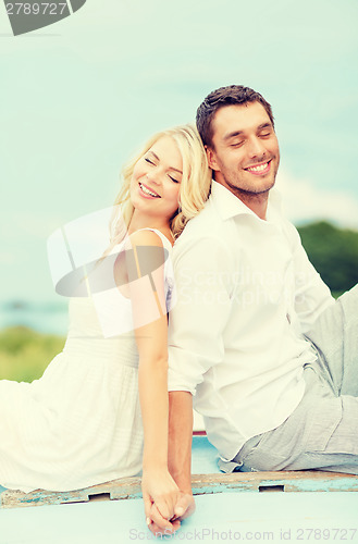 Image of smiling couple at sea side