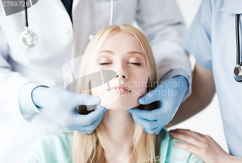 Image of plastic surgeon or doctor with patient