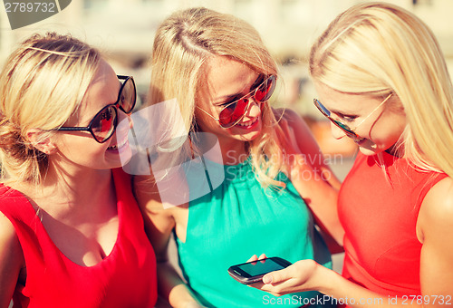 Image of beautiful girls with smartphone in the city