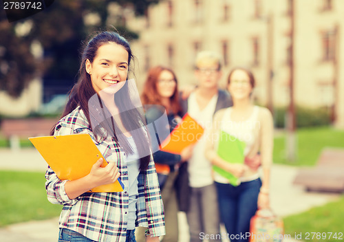 Image of smiling female student with folders