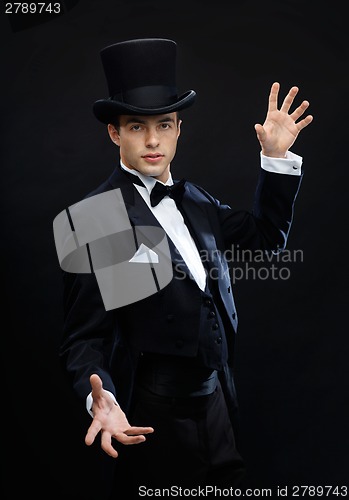 Image of magician in top hat showing trick