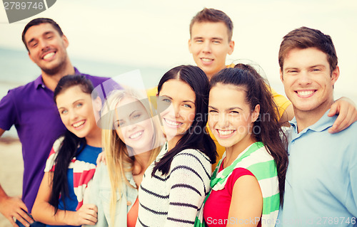 Image of group of friends having fun on the beach