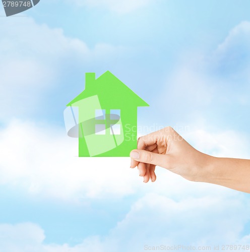 Image of hand holding green paper house