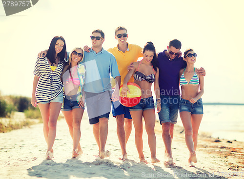 Image of group of friends having fun on the beach