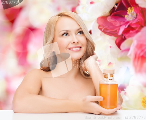 Image of happy woman with oil bottle