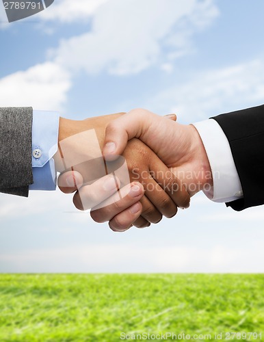 Image of businessman and businesswoman shaking hands