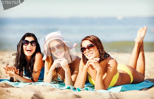 Image of girls sunbathing on the beach