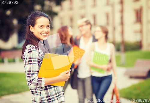 Image of teenage girl with folders and mates on the back