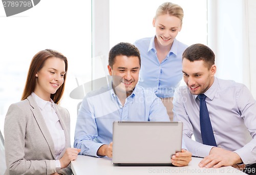 Image of business team working with laptop in office