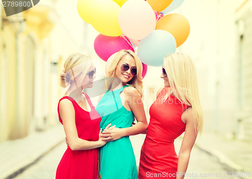 Image of beautiful girls with colorful balloons in the city