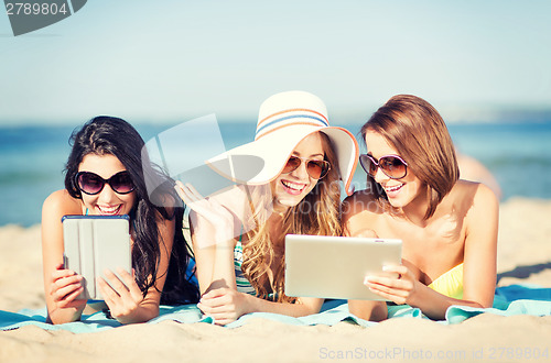 Image of girls with tablet pc on the beach