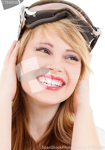 Image of smiling teenage girl in snowboard goggles