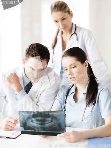 Image of group of doctors looking at x-ray