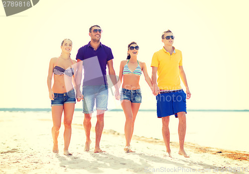 Image of group of friends having fun on the beach
