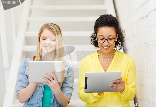 Image of smiling female students with tablet pc computer