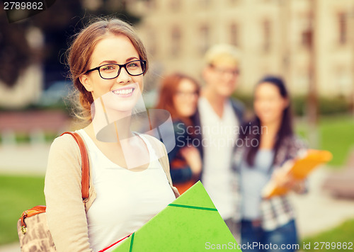 Image of female student in eyglasses with folders