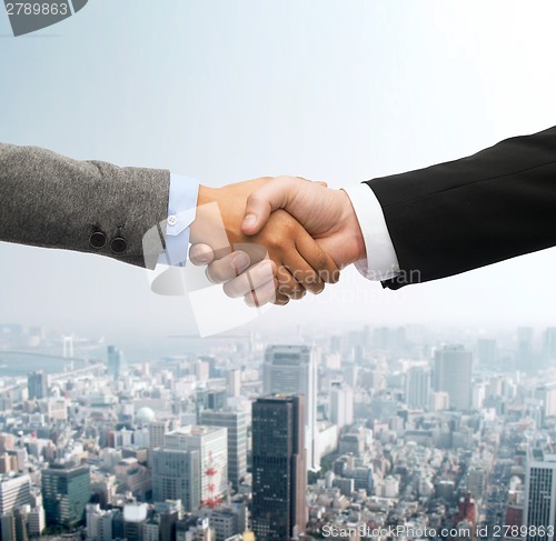 Image of businessman and businesswoman shaking hands