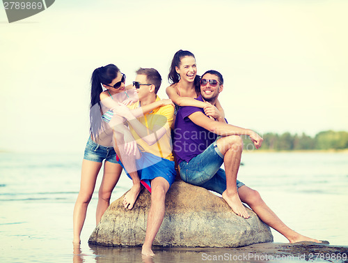 Image of group of friends having fun on the beach