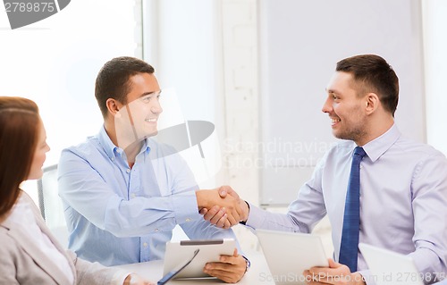 Image of business team working with tablet pc in office