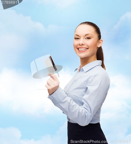 Image of smiling businesswoman showing credit card