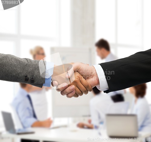 Image of businessman and businesswoman shaking hands