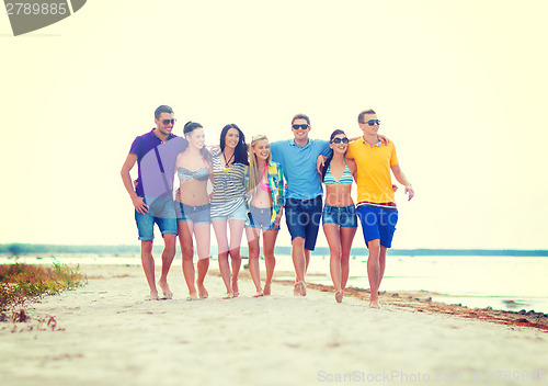 Image of group of friends having fun on the beach