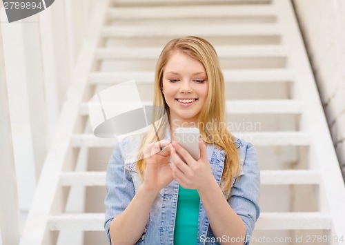 Image of smiling female student with smartphone