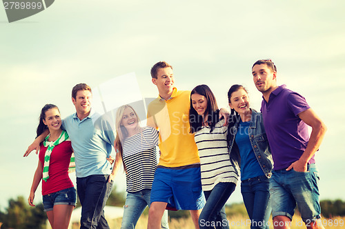 Image of group of friends having fun on the beach