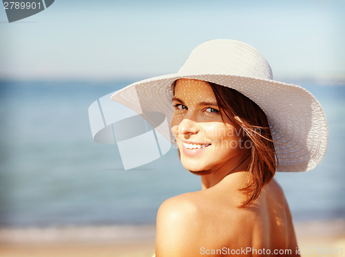 Image of girl in bikini standing on the beach