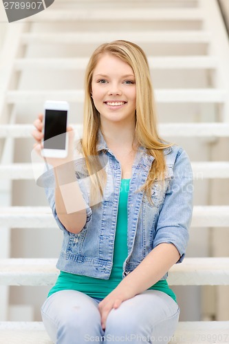 Image of smiling student with smartphone blank screen