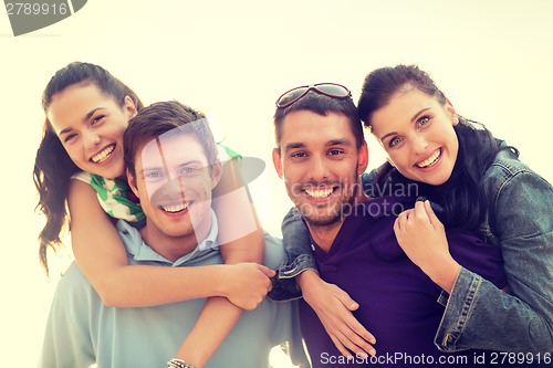 Image of group of friends having fun on the beach