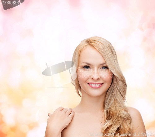 Image of face and shoulders of happy woman with long hair