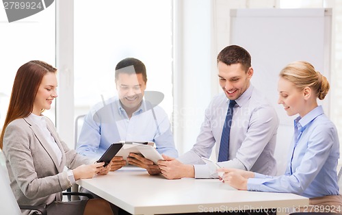 Image of business team working with tablet pc in office