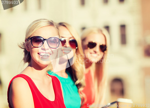 Image of women with takeaway coffee cups in the city