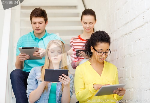 Image of calm students with tablet pc computer