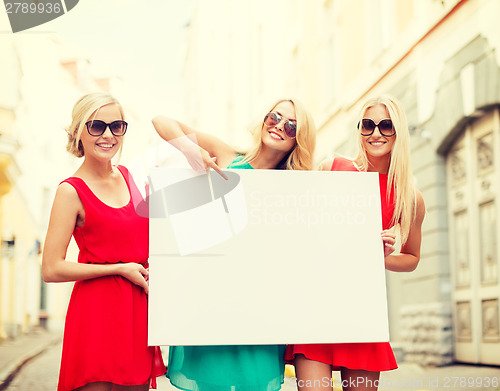 Image of three happy blonde women with blank white board