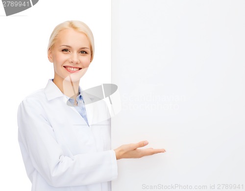 Image of smiling female doctor with white blank board