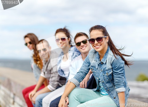 Image of smiling teenage girl hanging out with friends