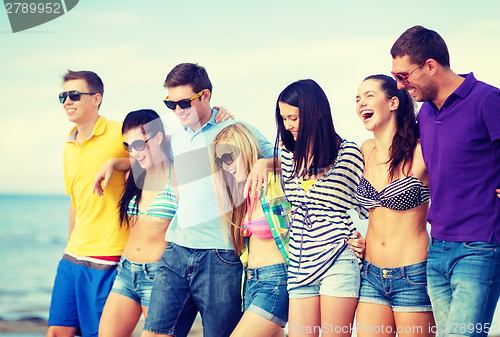 Image of group of friends having fun on the beach