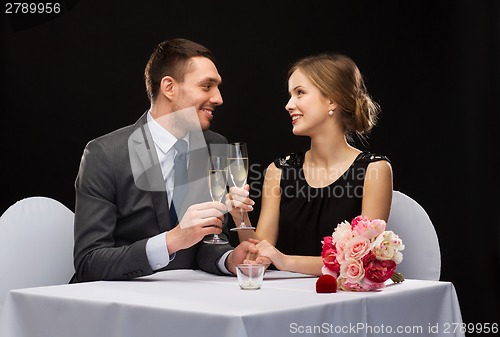 Image of couple with glasses of champagne at restaurant