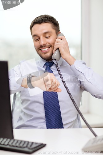 Image of smiling businessman making call