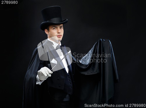 Image of magician in top hat with magic wand showing trick