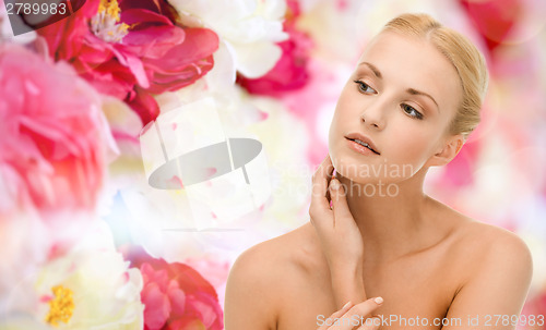 Image of beautiful woman touching her face skin