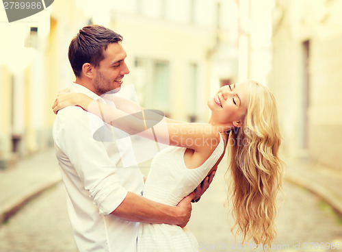 Image of smiling couple dancing in the city