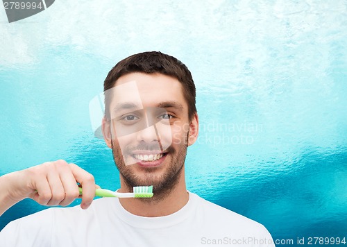 Image of smiling young man with toothbrush