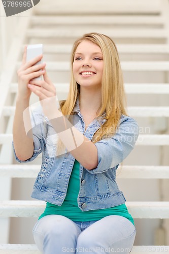 Image of smiling female student with smartphone