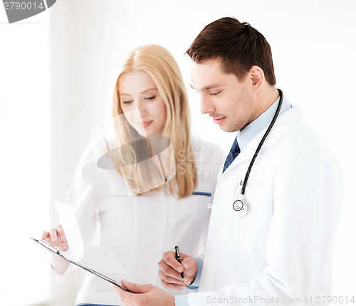 Image of two doctors writing prescription