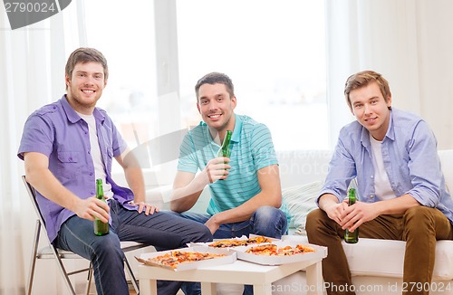 Image of smiling friends with beer and pizza hanging out